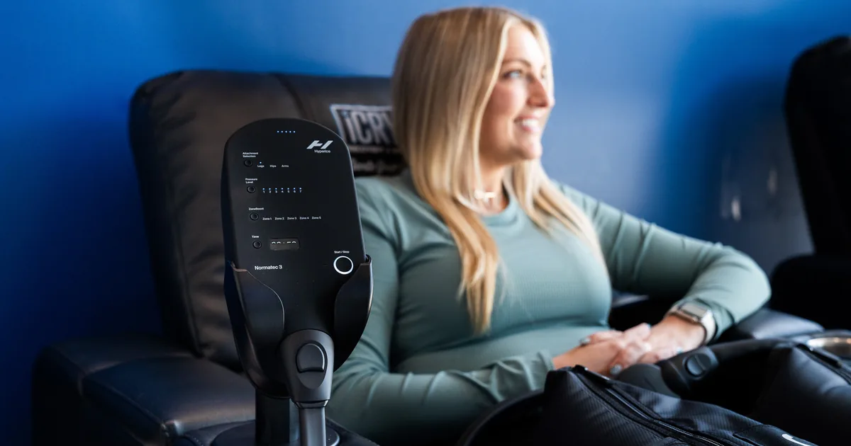 Runner relaxing during compression therapy for recovery at iCRYO Highland Village
