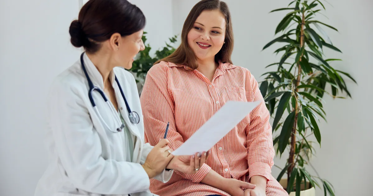 Provider measuring a patient's waist during a medical weight loss consultation at iCRYO Highland Village